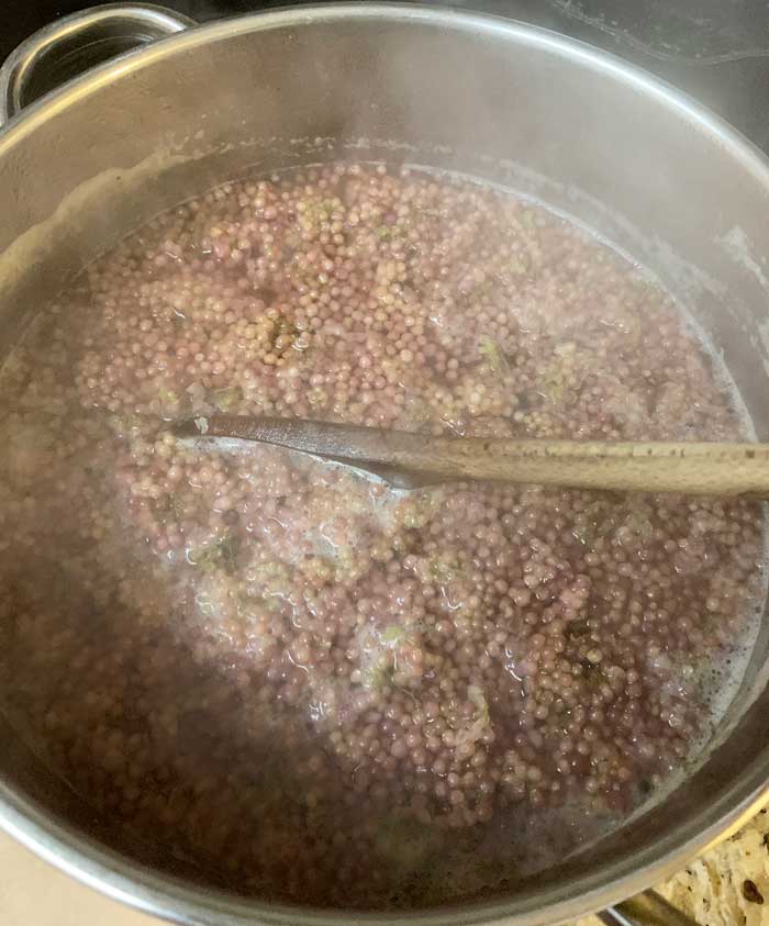 Your beautyberries will lose their color as you cook them. Don't worry! All that beautiful color stays in the final juice when you strain them.