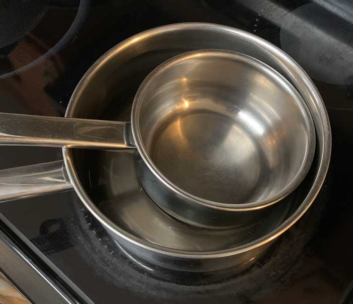 Here's how to make the double boiler mentioned in the recipe below. Larger pan on bottom with water in it. Smaller pan on top, floating on top of the water. This is an important cooking technique when using temperature-sensitive ingredients like gelatin.
