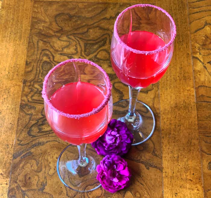 Our fermented rose cordial is made with the whole rose flower head and the glasses are rimmed with fermented rose petal powder. 