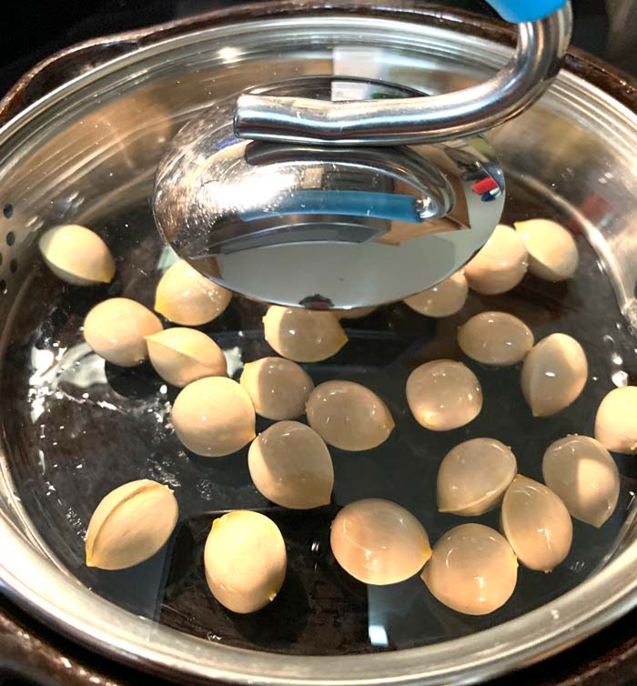 Cooking Ginkgo nuts in a covered cast iron skillet.