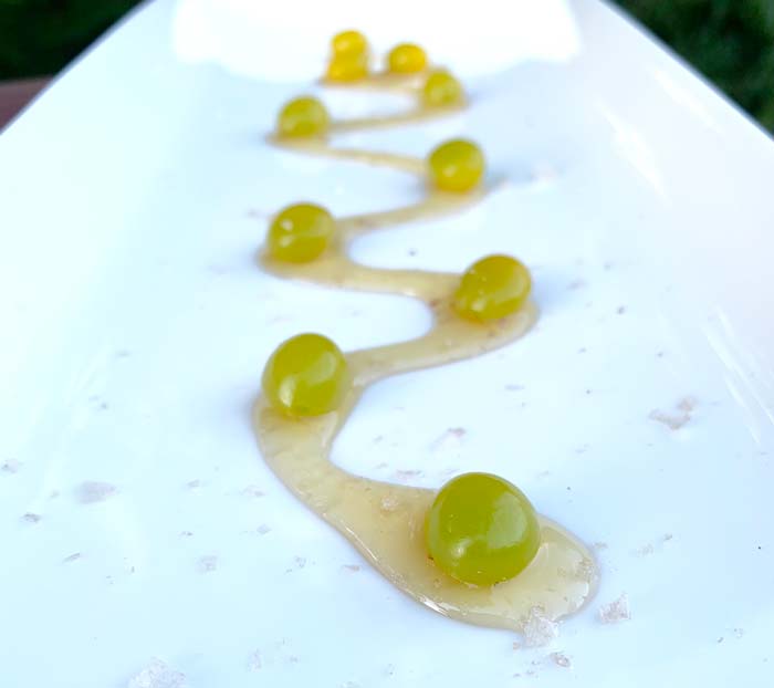 Pan-roasted Ginkgo nuts served on a stream of honey from our backyard and lightly dusted with smoked salt.