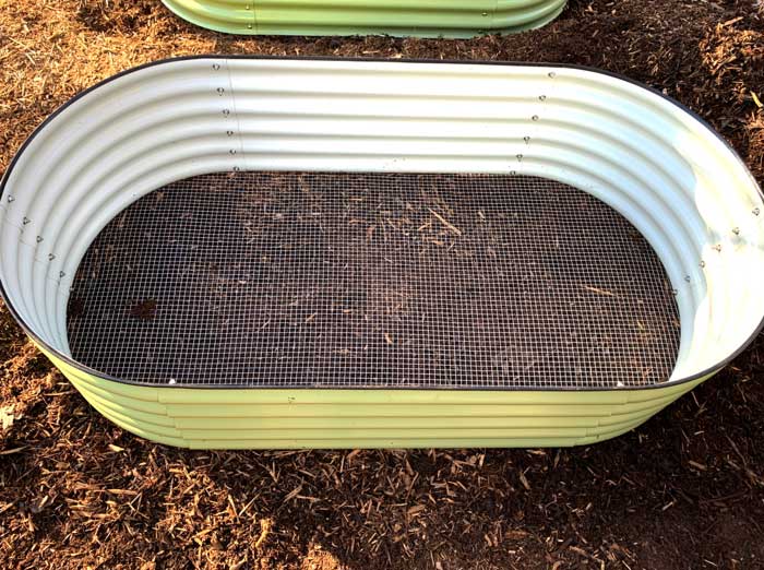 How to vole-proof a raised bed. Here's one of our raised metal garden beds before we filled it. You can see the 1/2